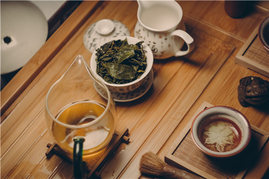 white-ceramic-teapot-beside-cup-with-leaves-229493.jpg